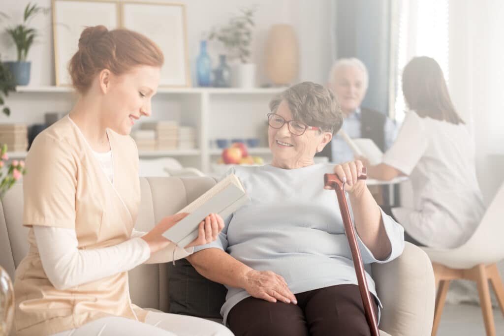 Friendly caregiver and elderly woman